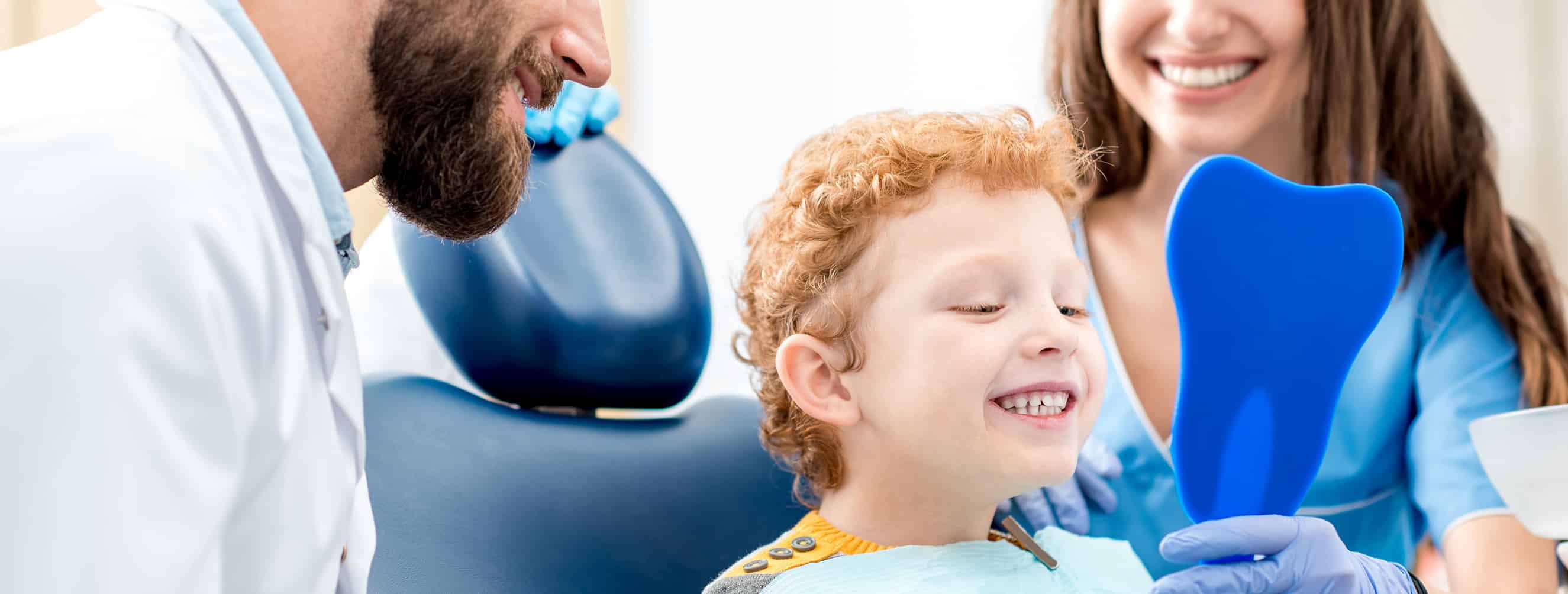 Happy Child looking at his teeth after visiting a pediatric Dentist in Cincinnati OH